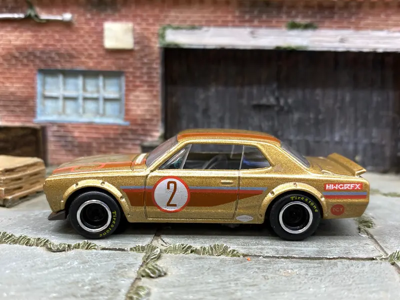 Custom Hot Wheels Nissan Skyline H/T 2000Gt-X In Gold 2 With Chrome And Black Smooth Wheels With Firestone Rubber Tires 1